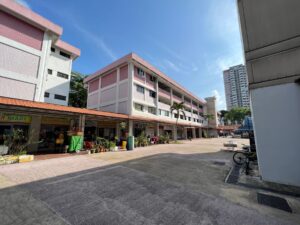 Open air shopping arcade nestled within the older HDB blocks at Avenue 2